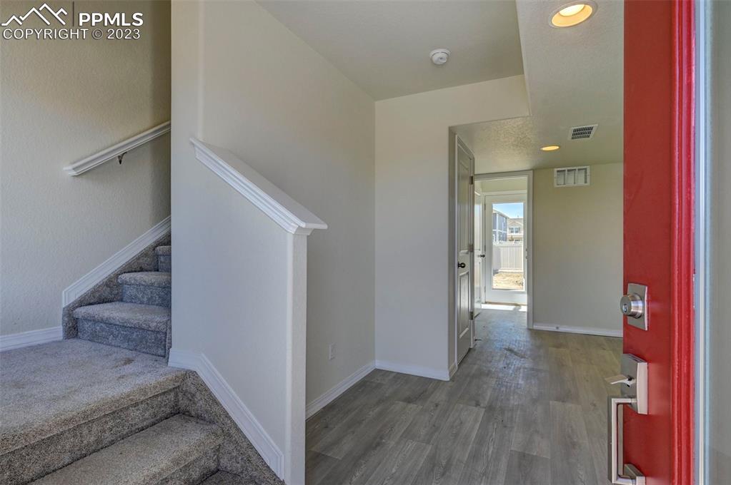 11270 Feliz Way Fountain, CO 80817 - Photo 7 of 42 a view of a hallway with entryway and wooden floor