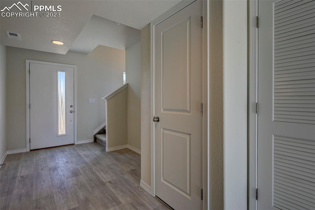 11270 Feliz Way Fountain, CO 80817 - Photo 9 of 42 a view of an entryway with wooden floor