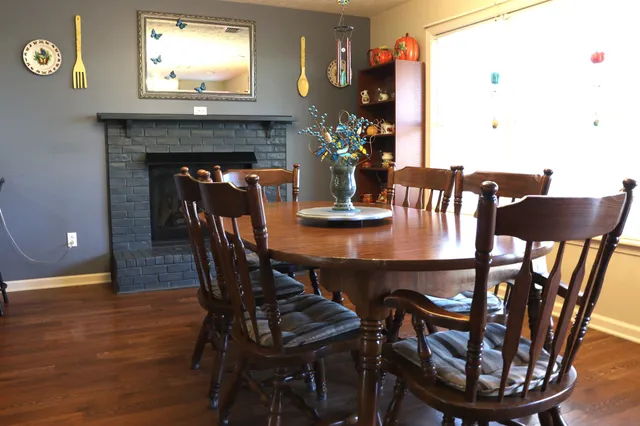 a dining room with furniture and wooden floor