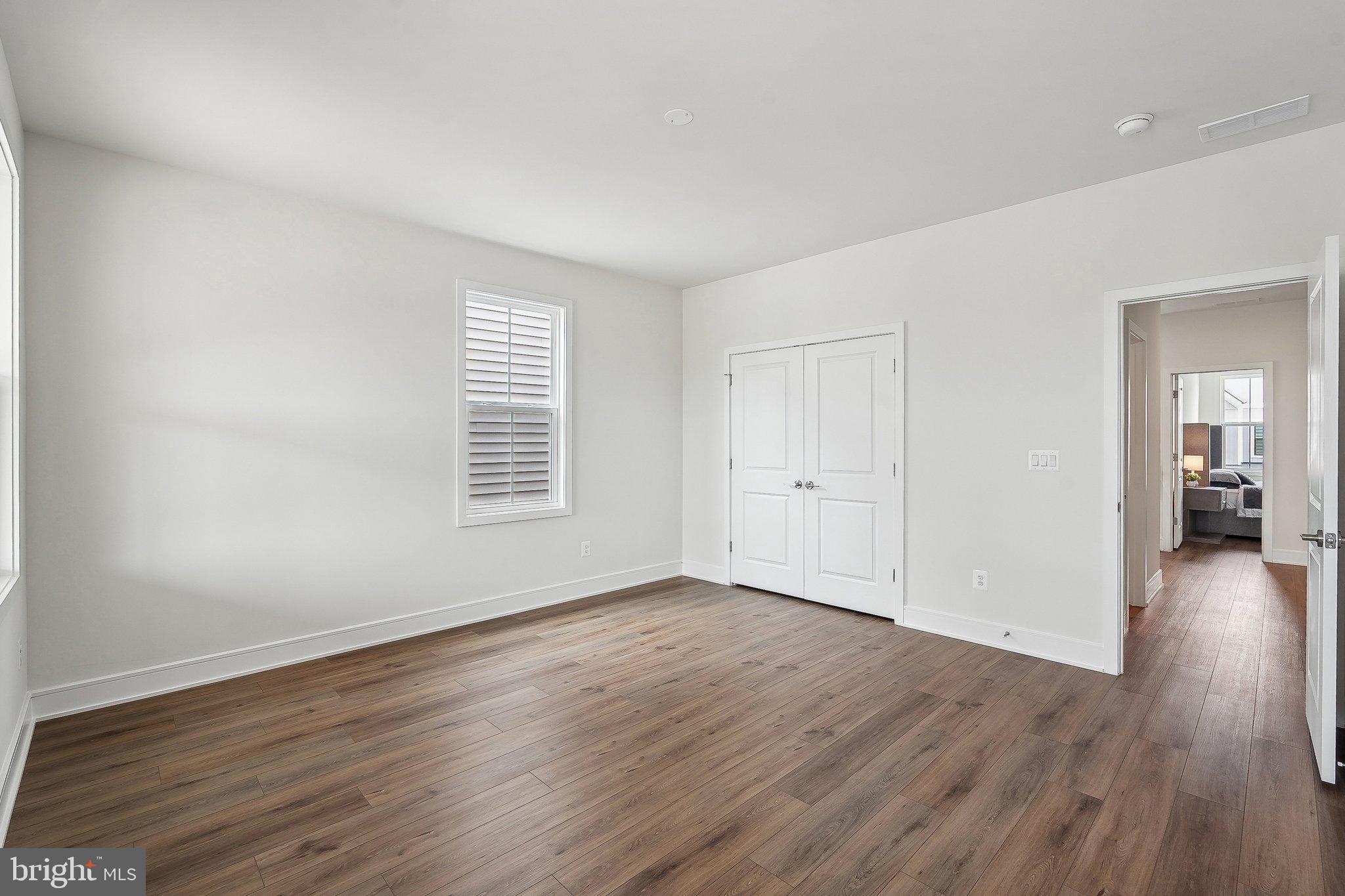 43244 Greeley Square Ashburn, VA 20148 - Photo 21 of 43 a view of an empty room with wooden floor and a window