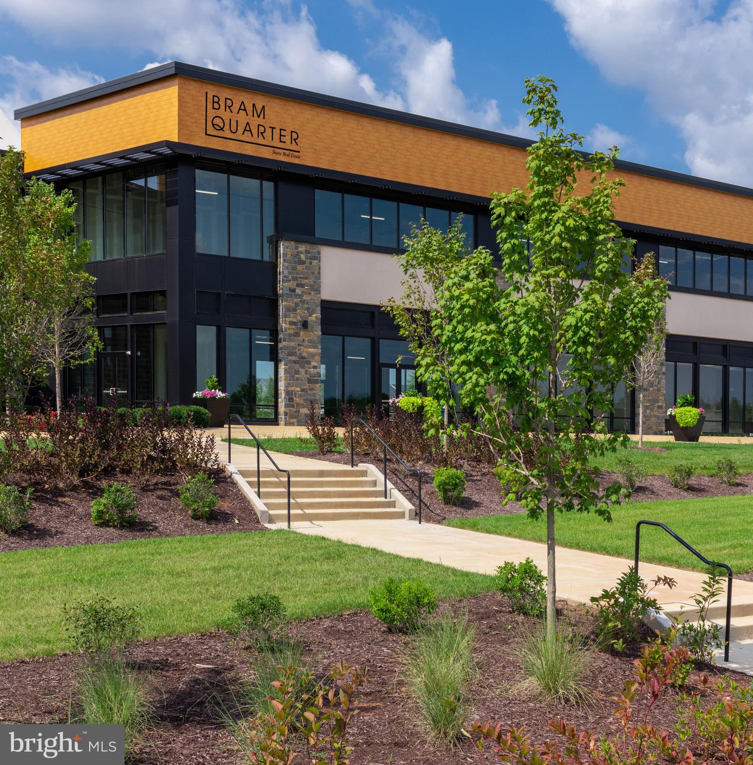 43244 Greeley Square Ashburn, VA 20148 - Photo 43 of 43 a view of a house with brick walls and a yard with plants