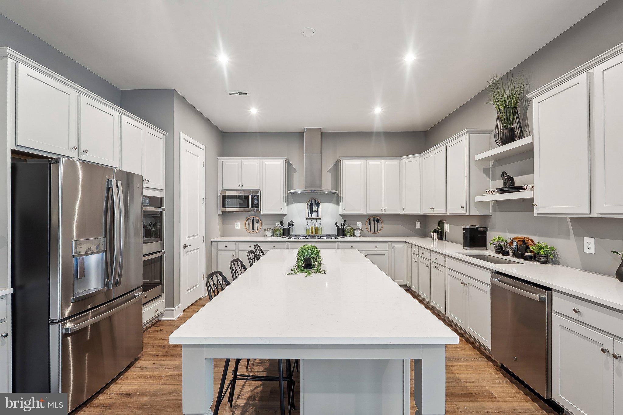 43244 Greeley Square Ashburn, VA 20148 - Photo 5 of 43 a kitchen with white cabinets and stainless steel appliances