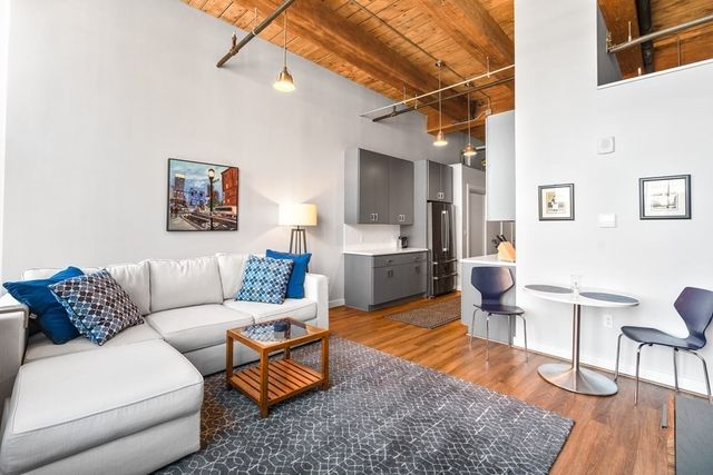 a living room with furniture and a rug