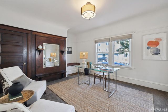 a living room with furniture a rug and a window