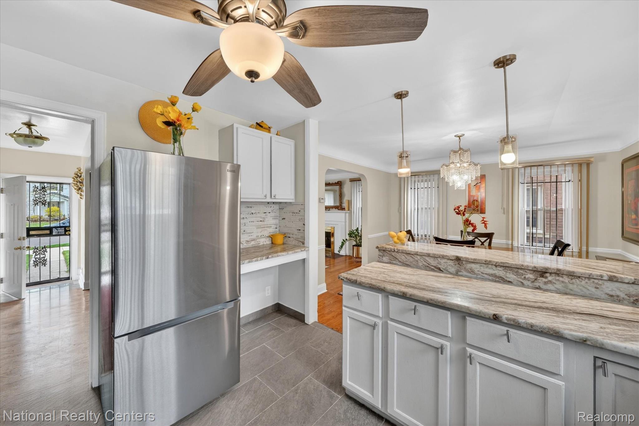 3956 Harvard Road Detroit, MI 48224 - Photo 14 of 44 Kitchen featuring white cabinets, freestanding refrigerator, light stone countertops, pendant lighting, and a ceiling fan