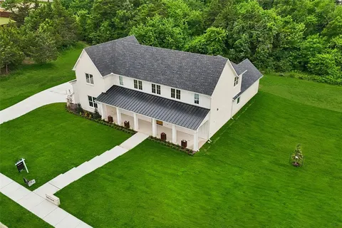a aerial view of a house next to a big yard
