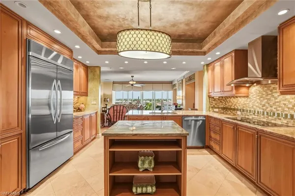 a kitchen with stainless steel appliances granite countertop a stove and a refrigerator