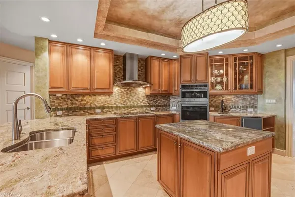 a kitchen with stainless steel appliances granite countertop a sink stove and cabinets