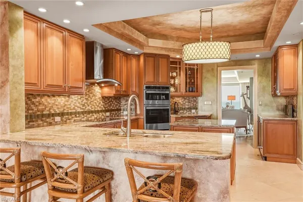 a kitchen with stainless steel appliances granite countertop a sink and cabinets