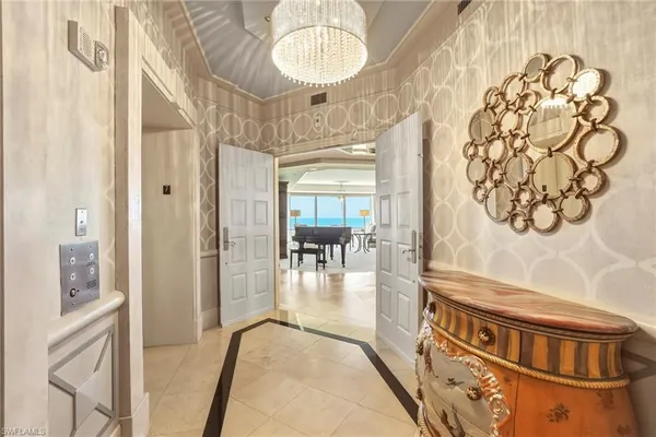 a view of a hallway to a livingroom with furniture