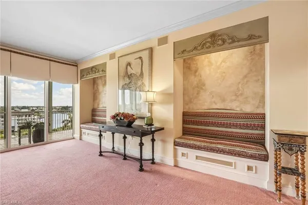 a living room with furniture and a floor to ceiling window