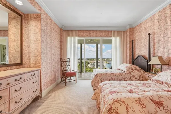 a large bedroom with a bed and large windows