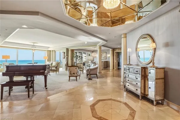 a living room with furniture a mirror and a clock