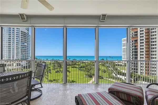 a balcony with furniture and a window