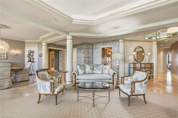 a living room with furniture and a large mirror