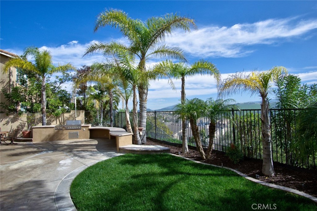 a view of a house with a yard and potted plants