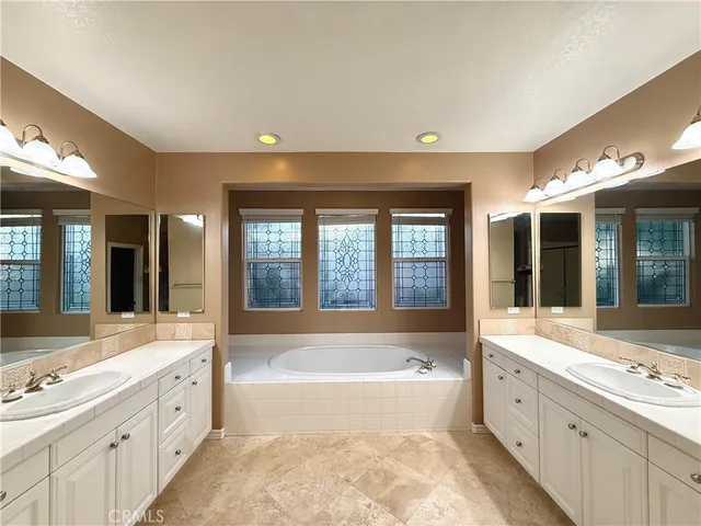 a large spacious bathroom with a large tub and sink