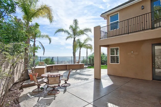 a view of a patio with table and chairs and potted plants