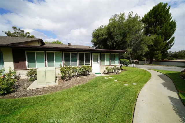 a view of house with a yard