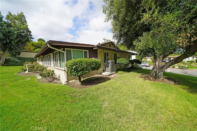 a view of a house with a yard and plants