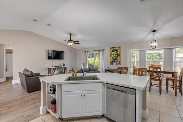 a kitchen with a stove a table and chairs