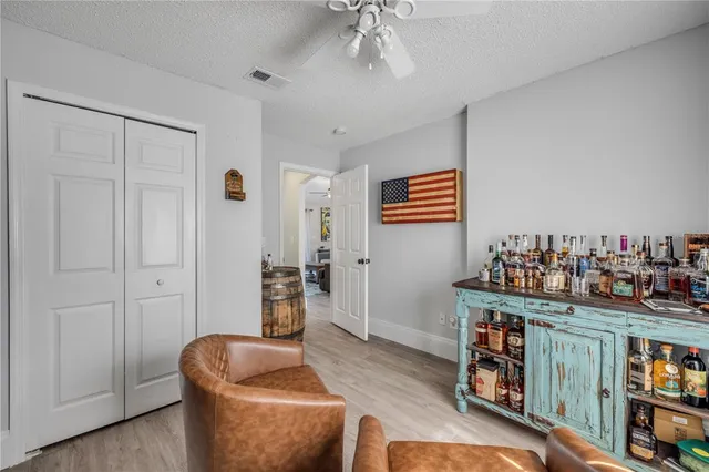 a livingroom with fridge and workspace