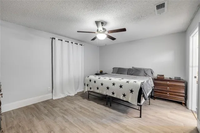 a bedroom with a bed and a ceiling fan