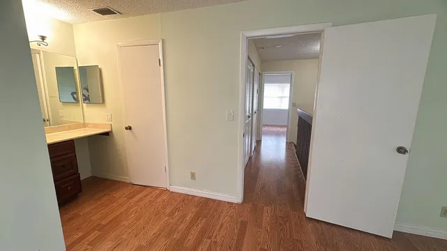 a view of hallway with wooden floor