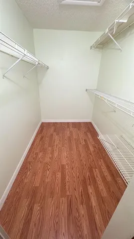 a view of a room with wooden floor