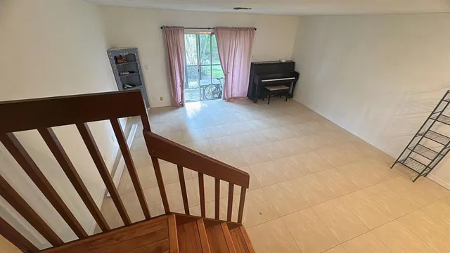a view of a livingroom with furniture and staircase