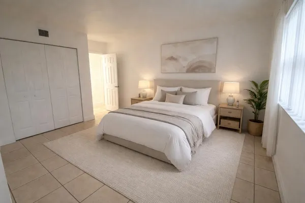 a bedroom with a bed and a lamp