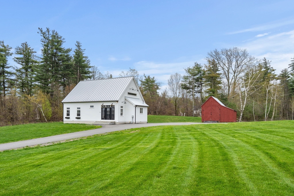 29 Heywood Road Ashby, MA 01431 - Photo 1 of 33 a view of a house with a yard and basketball court