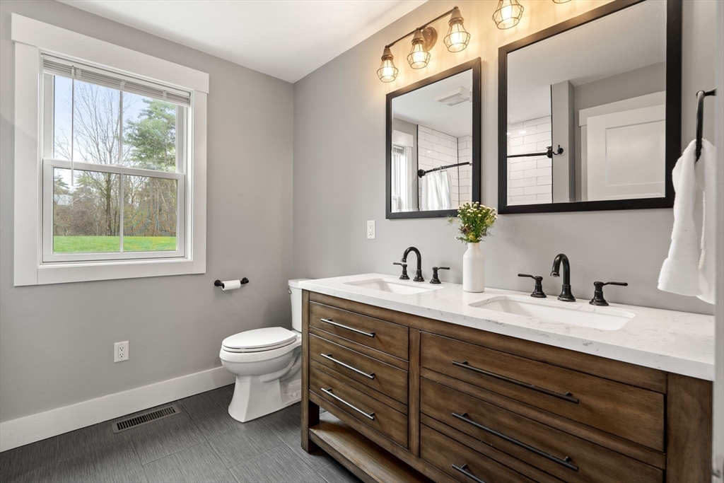 29 Heywood Road Ashby, MA 01431 - Photo 19 of 33 a bathroom with a granite countertop toilet sink and mirror