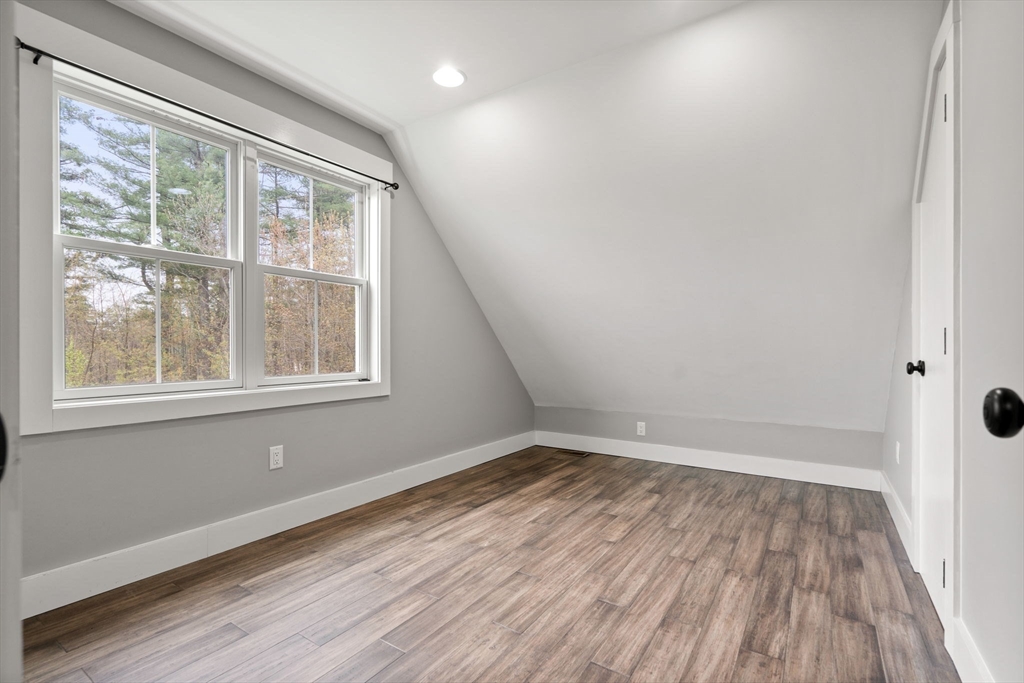 29 Heywood Road Ashby, MA 01431 - Photo 23 of 33 an empty room with wooden floor and windows