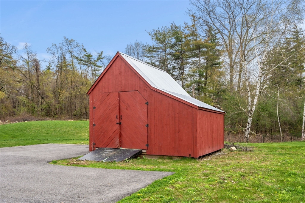29 Heywood Road Ashby, MA 01431 - Photo 31 of 33 a view of backyard with large trees and wooden fence