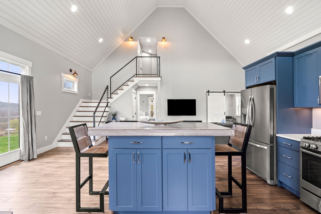 29 Heywood Road Ashby, MA 01431 - Photo 5 of 33 a kitchen with kitchen island a dining table and chairs