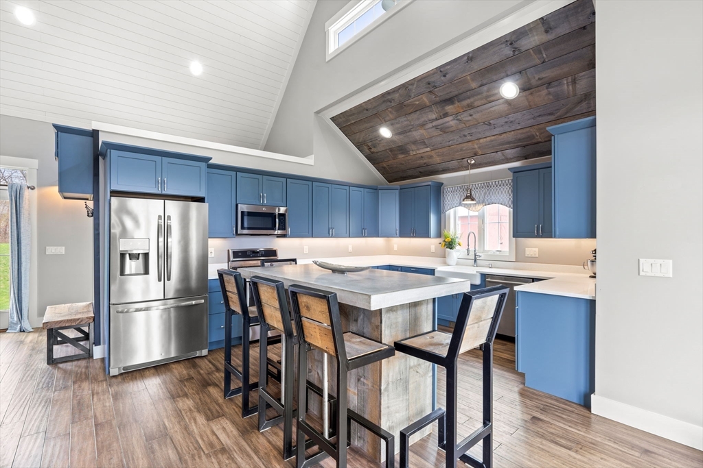 29 Heywood Road Ashby, MA 01431 - Photo 6 of 33 a kitchen with a table chairs refrigerator and cabinets