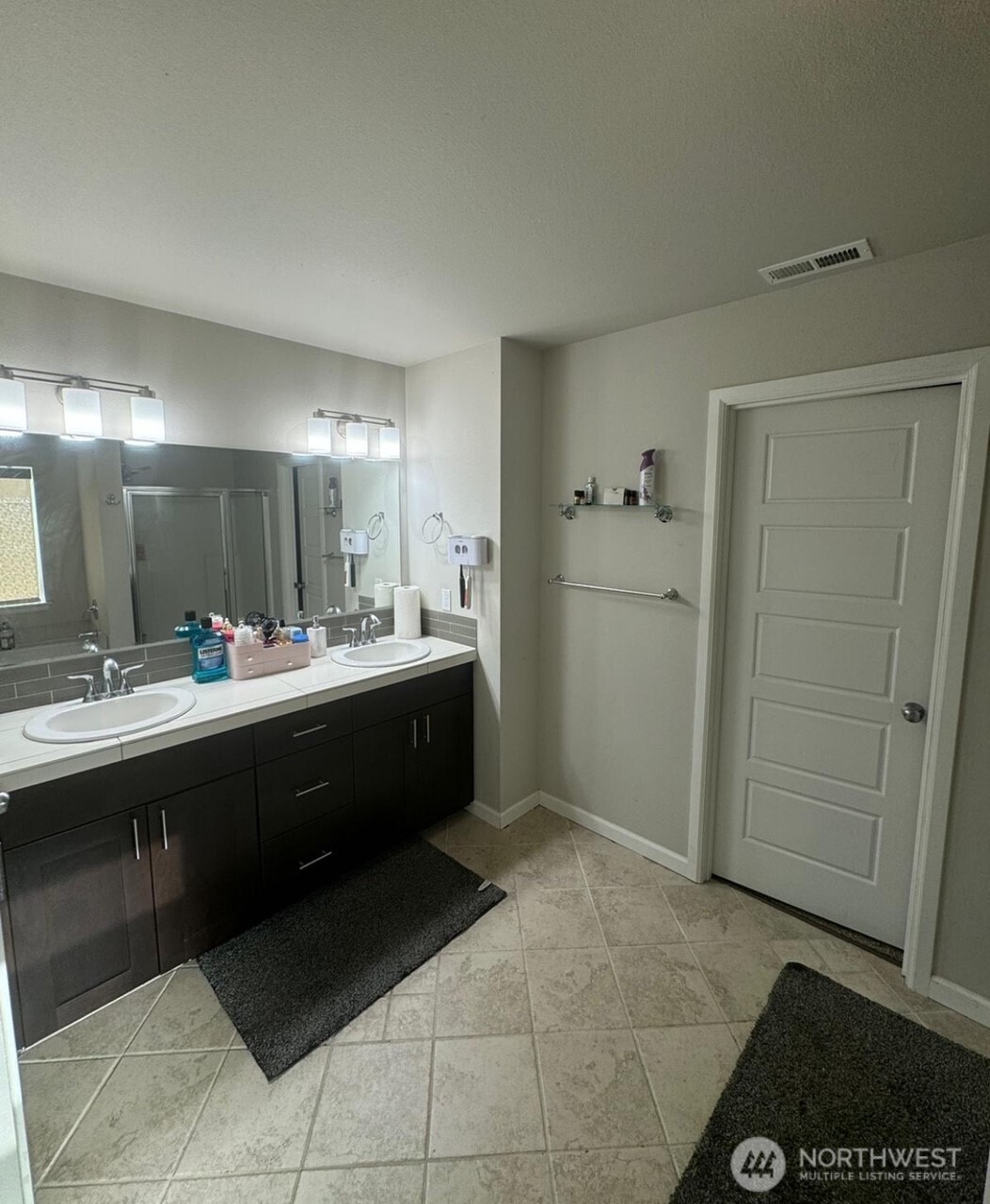 9976 Charles Street Southeast Yelm, WA 98597 - Photo 14 of 30 a large bathroom with a double vanity sink a mirror and a shower