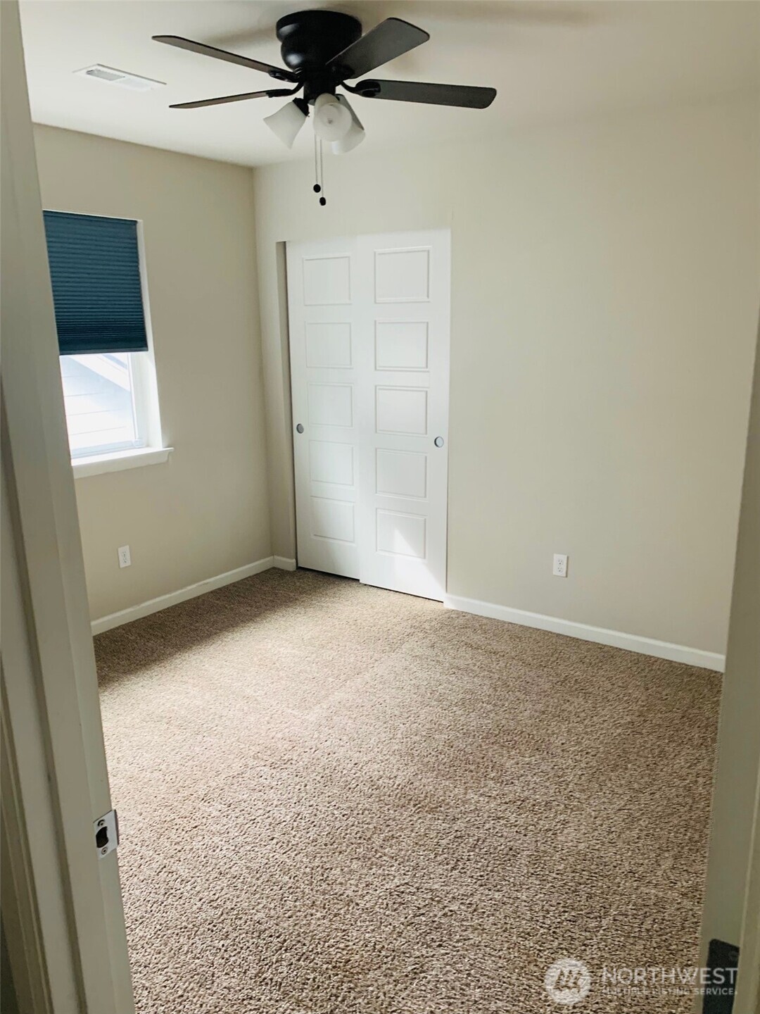 9976 Charles Street Southeast Yelm, WA 98597 - Photo 22 of 30 an empty room with a ceiling fan and a window