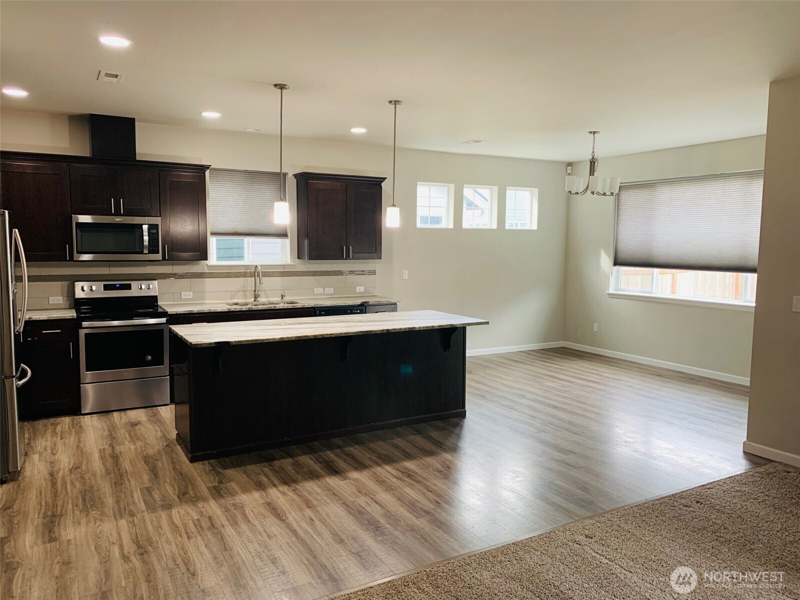 9976 Charles Street Southeast Yelm, WA 98597 - Photo 6 of 30 a kitchen with stainless steel appliances granite countertop a sink a stove and a wooden floors
