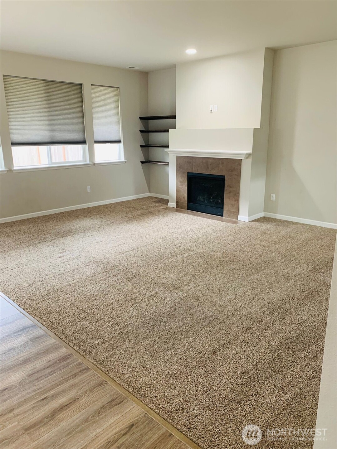 9976 Charles Street Southeast Yelm, WA 98597 - Photo 9 of 30 an empty room with windows and fireplace