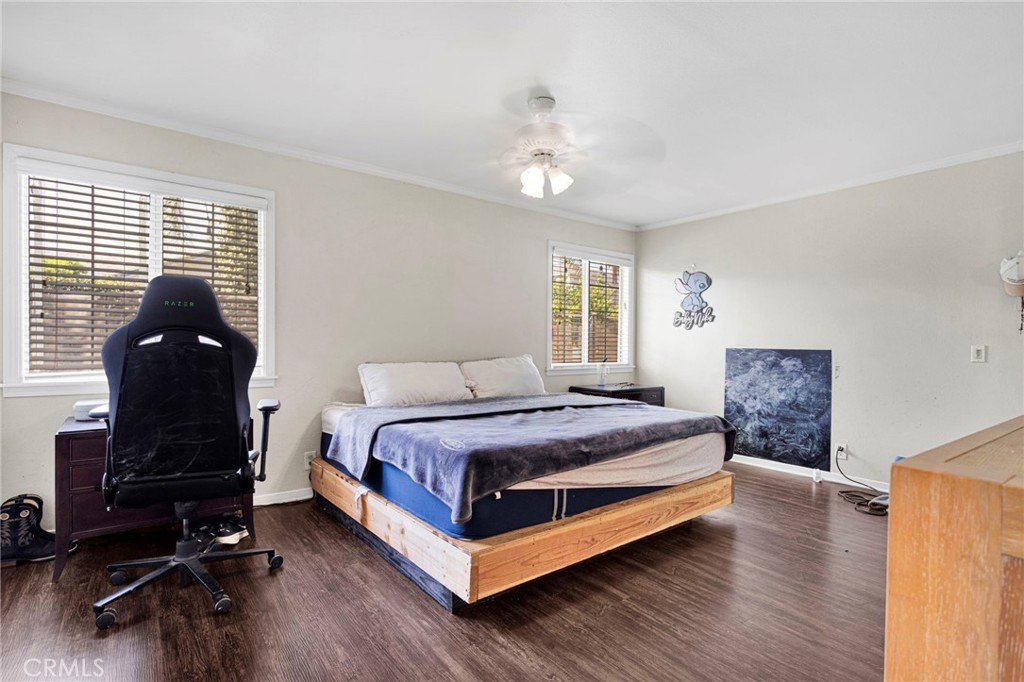 1087 Baseline Road La Verne, CA 91750 - Photo 26 of 39 a spacious bedroom with a bed a dresser and wooden floor