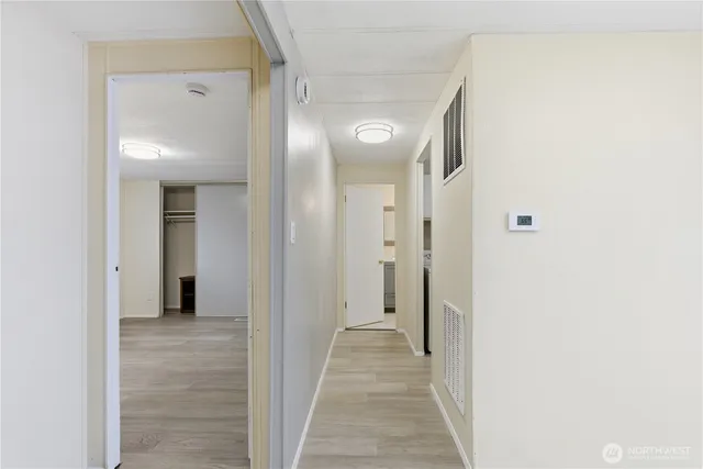 a view of a hallway with wooden floor
