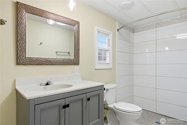 a bathroom with a toilet sink and mirror