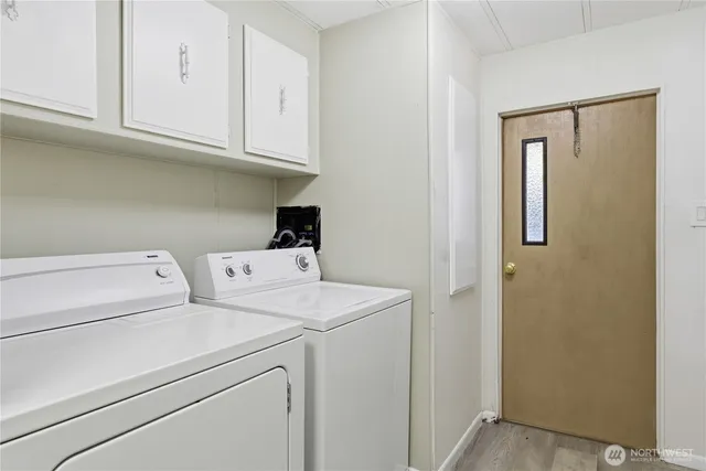 a view of storage and utility room with washer and dryer
