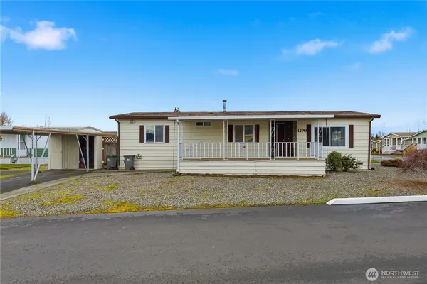 a view of a house with swimming pool and sitting area