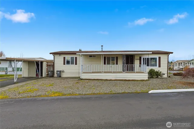 a view of a house with swimming pool and sitting area