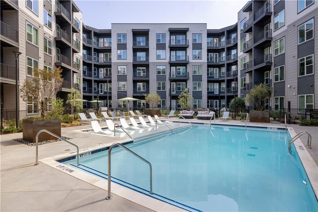 a view of building with swimming pool and sitting space