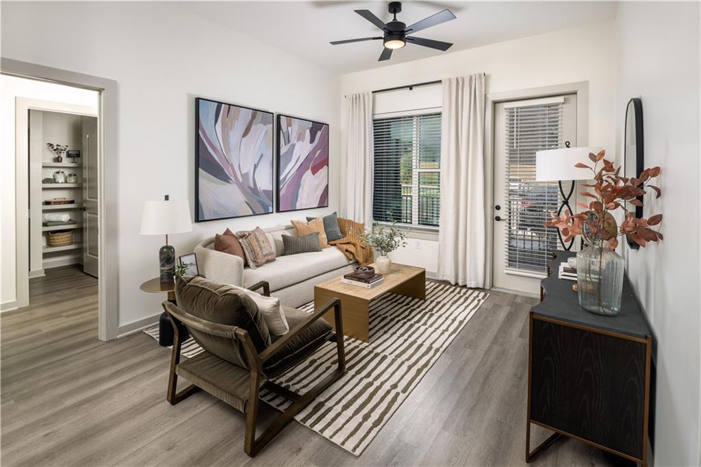 3108 McGinnis Ferry Road, Unit A6 Suwanee, GA 30024 - Photo 11 of 17 a living room with furniture and wooden floor