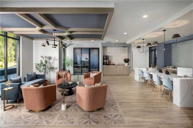 a living room with furniture a large window and a table